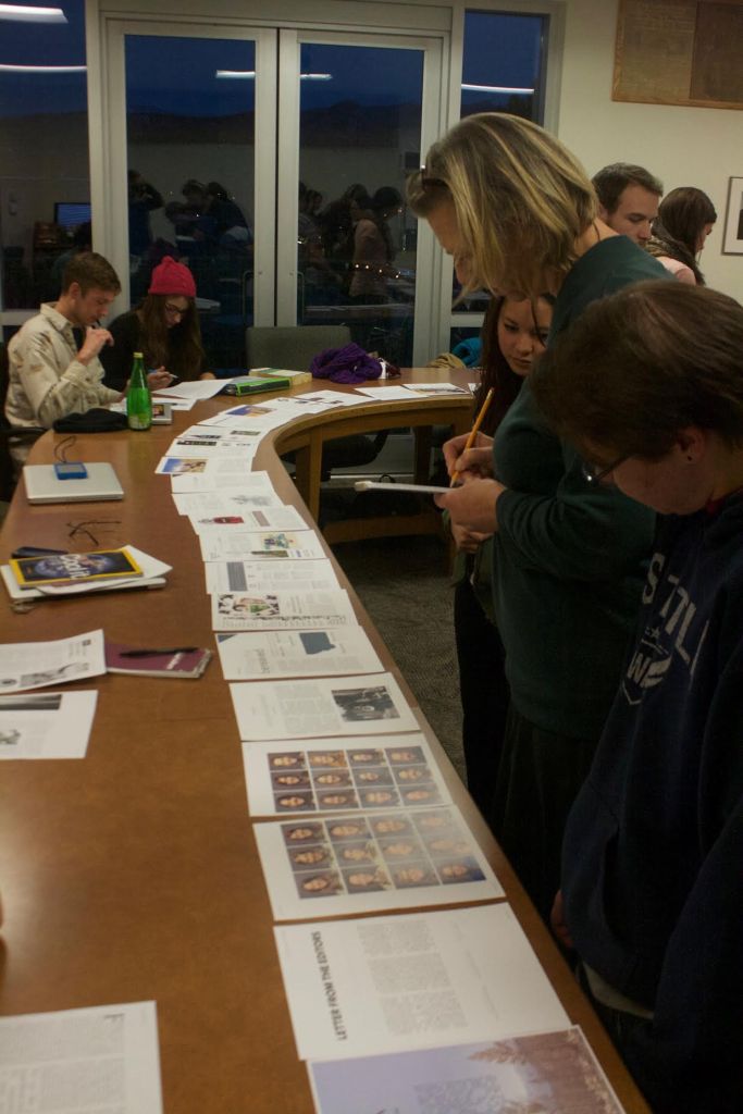 Page by page, faculty advisor Henriette Lowisch and members of the MJR staff go through their magazine, looking for errors in copy or design.