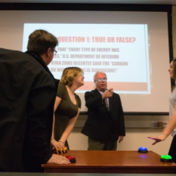 Professor Dennis Swibold moderates his Fake News Game Show, in which students guess, "Is it real or is it fake?" with buzzers and everything. Photo by Jamie Drysdale.